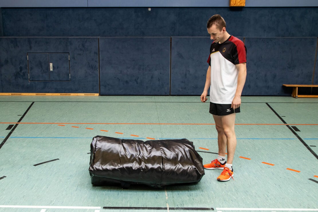 a gymnast looking at a fully packed gymnastics air bag from BAGJUMP