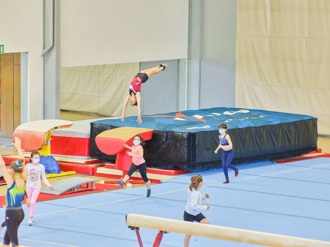 gymnast practicing vault onto a gymnastics air bag landing.