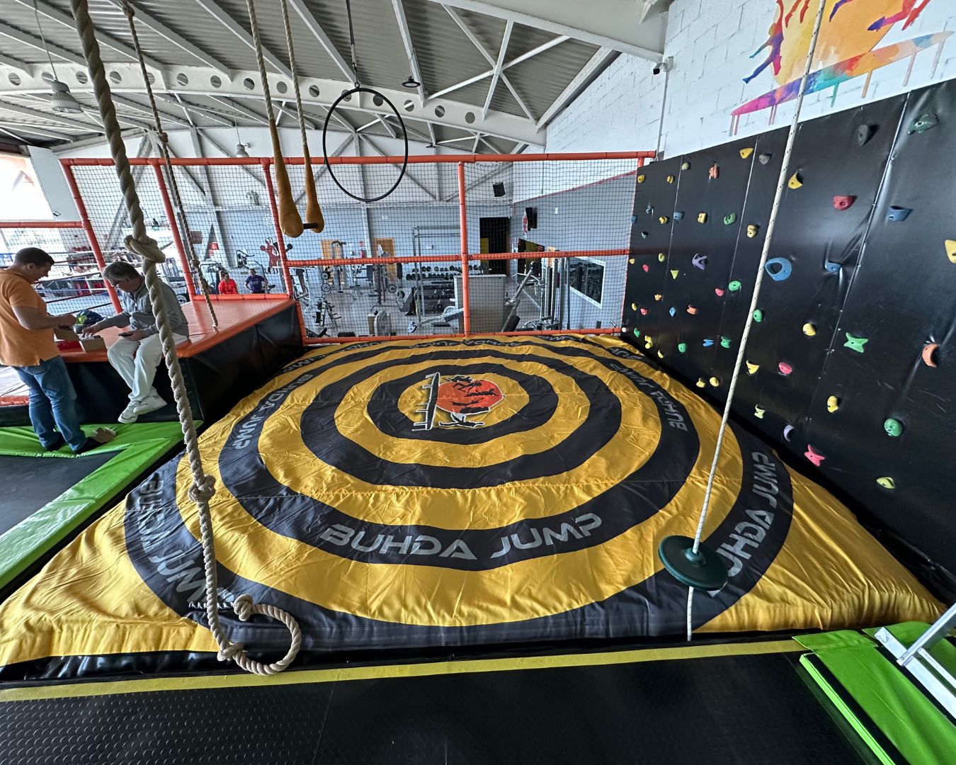Budha Jump Location: Girona, Spain Facility Type: Trampoline Center Installation: Full foam pit replacement Setup: Inground airbag for climbing wall Drop zone for trampoline lanes